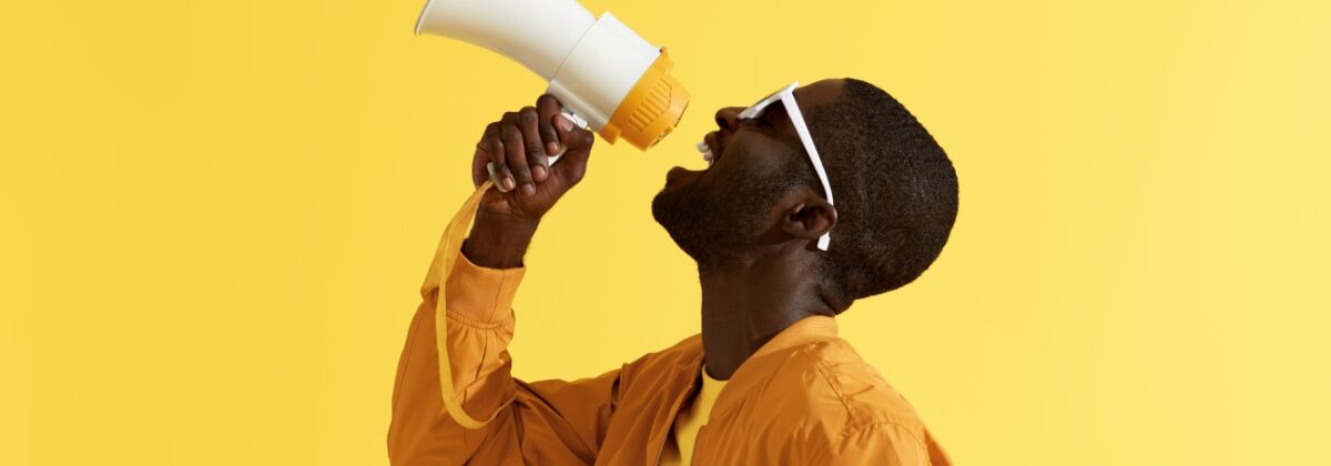 Black man yelling into megaphone