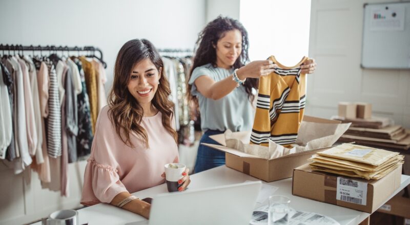 Two women working in small clothing business