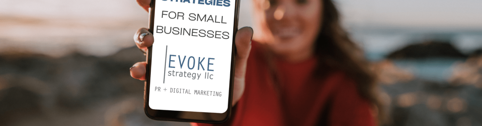 out of focus woman holding a cell phone with the text "Mobile Marketing Strategies For Small Businesses"