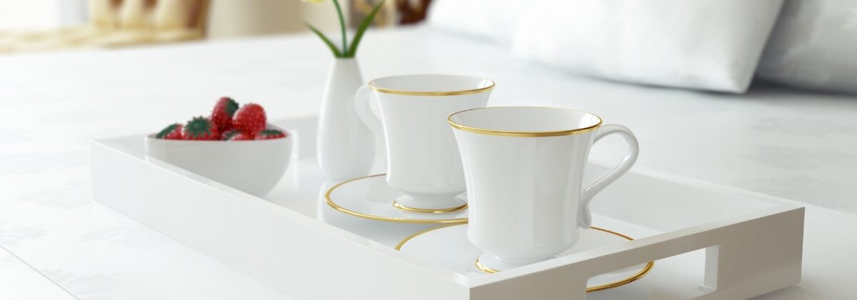 Tray with cups on bed