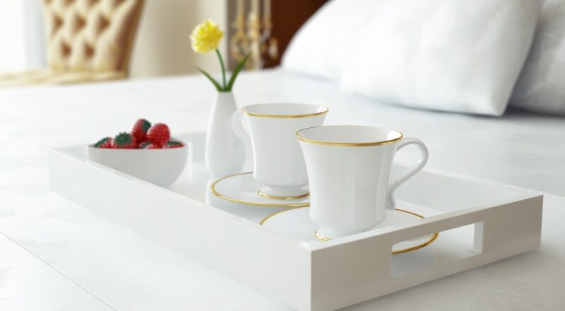 Tray with cups on bed