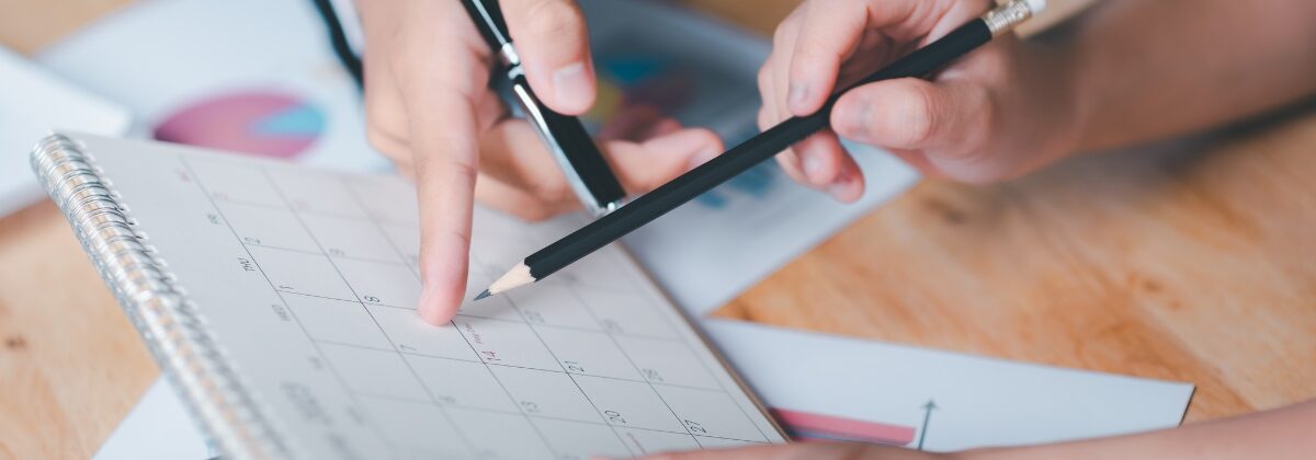 pencils pointing at calendar
