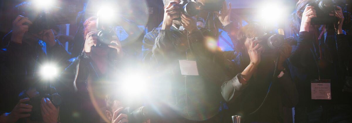 paparazzi cameras flashing